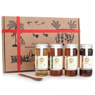 Four jars of honey with a decorative box featuring tribal designs on a white background