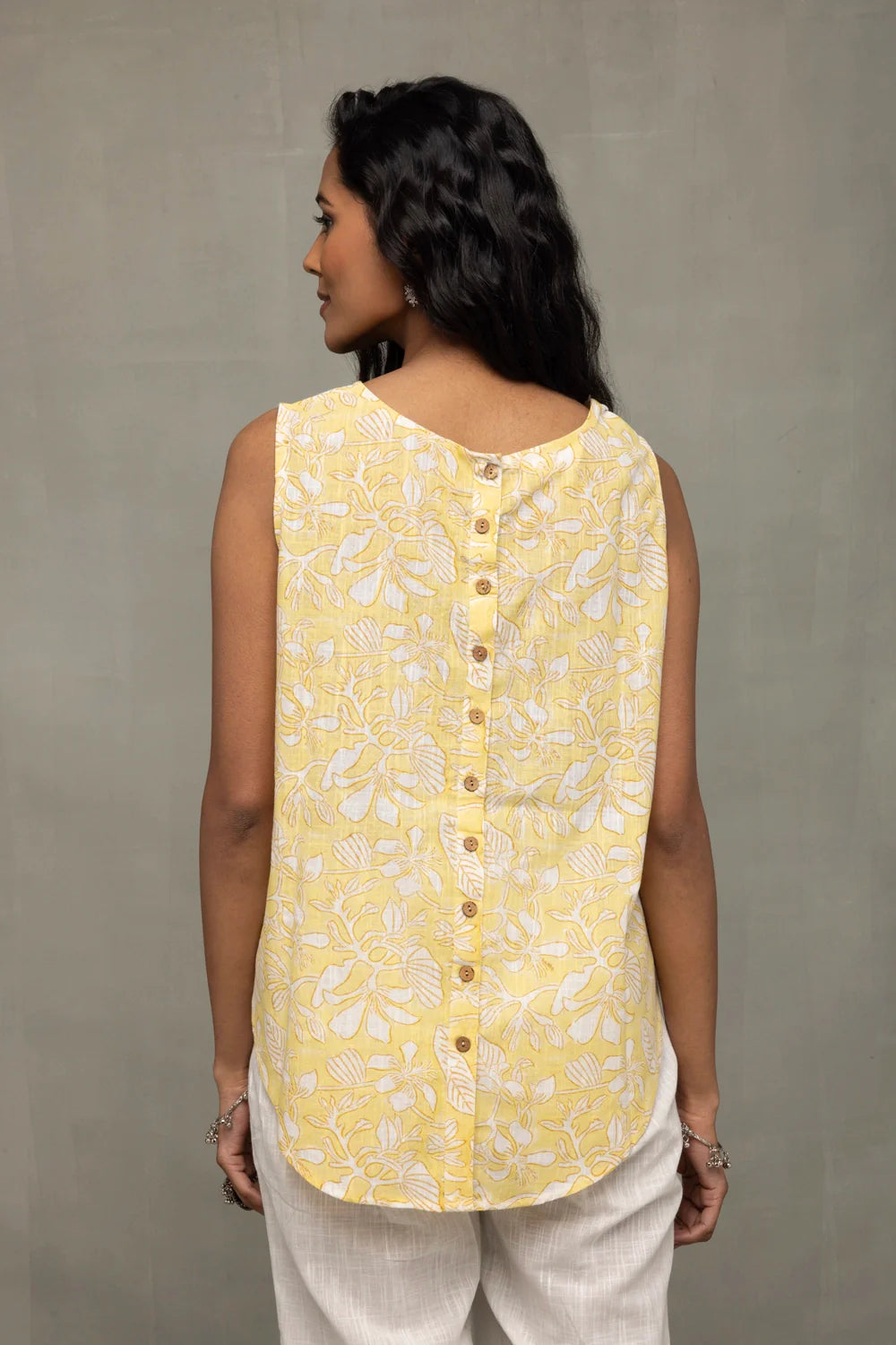 Back View of Sunshine Yellow Top Showcasing White Print and Buttoned Back Pattern