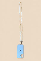 A light blue phone case with a white woven lanyard strap featuring small gold beads, shown on a solid beige background.